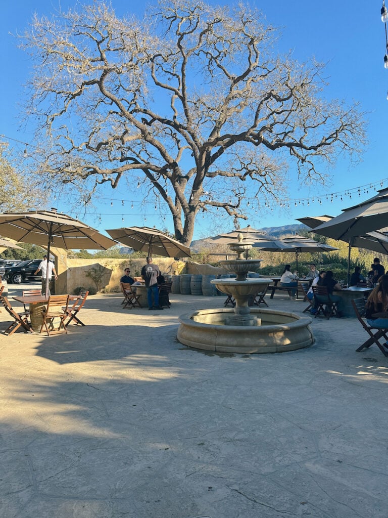 The courtyard at Sunstone Winery, which features a fountain surrounded by tables