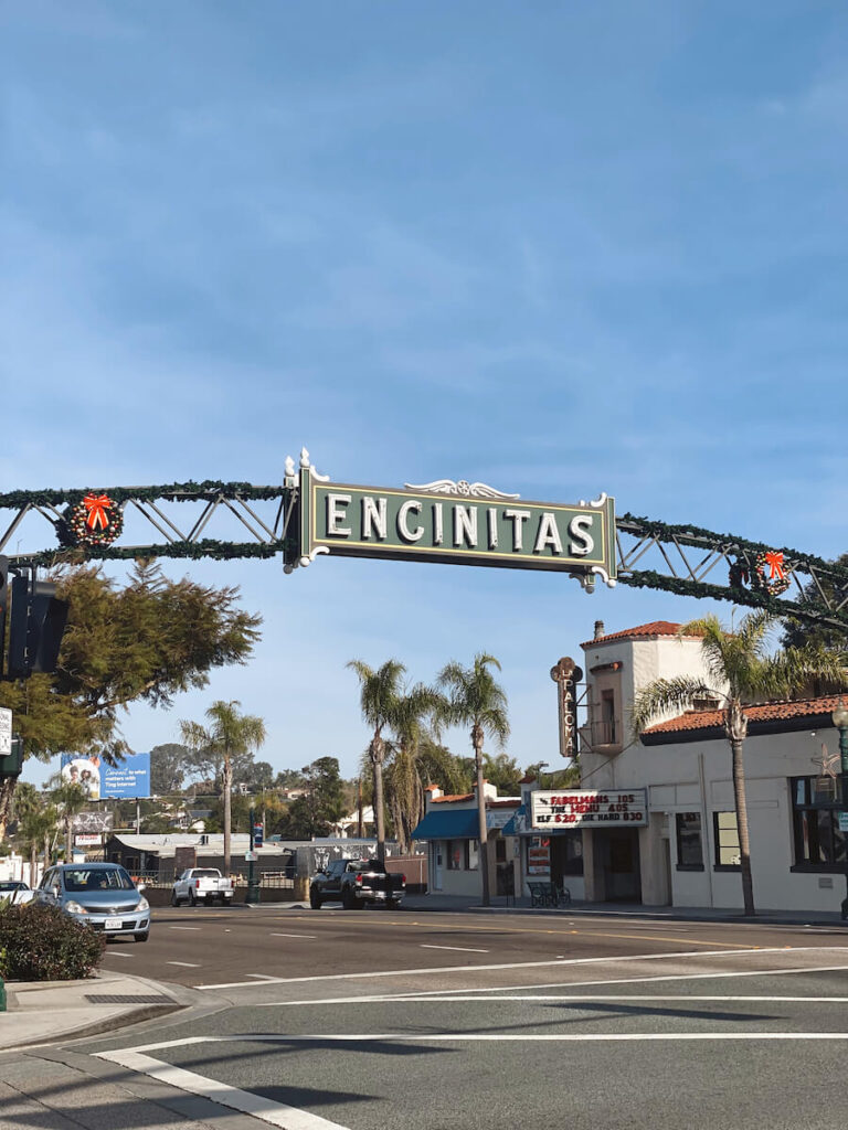 The Encinitas Sign over Highway 101, which has Christmas wreaths on either side.