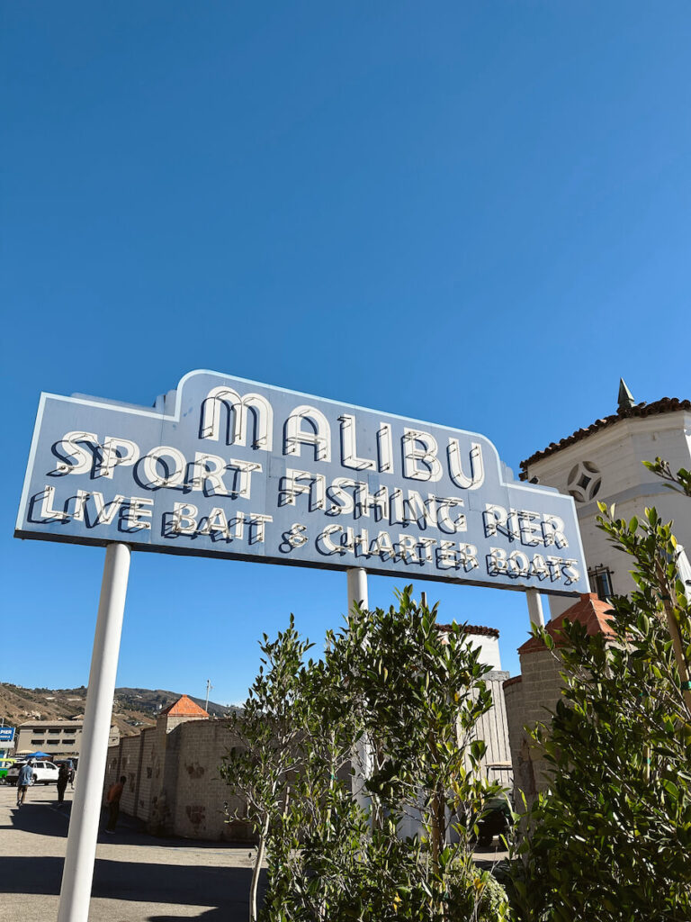 The Malibu Pier sign, which reads Malibu Sport Fishing Pier, Live Bait & Charter Boats