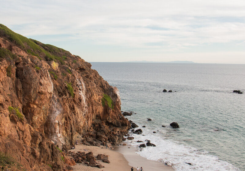 View of a rocky beach and coastal cliffs from above on the Point Dume Trail