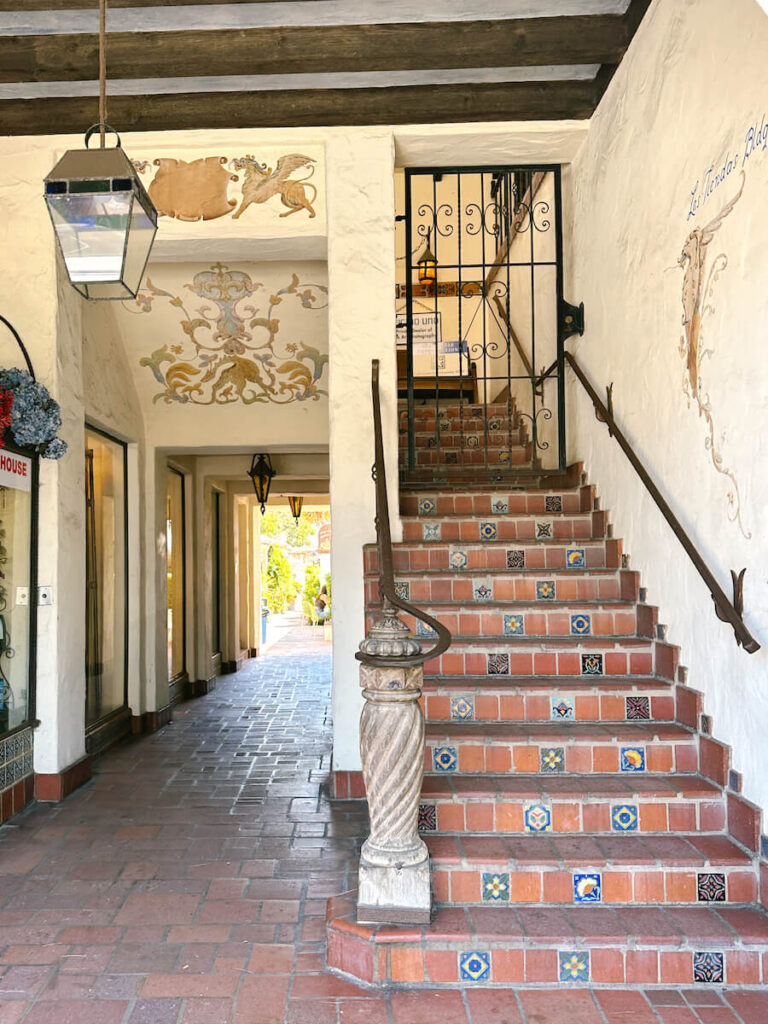 Tiled outdoor stairs and a pathway with a lamp over it in a courtyard in Carmel