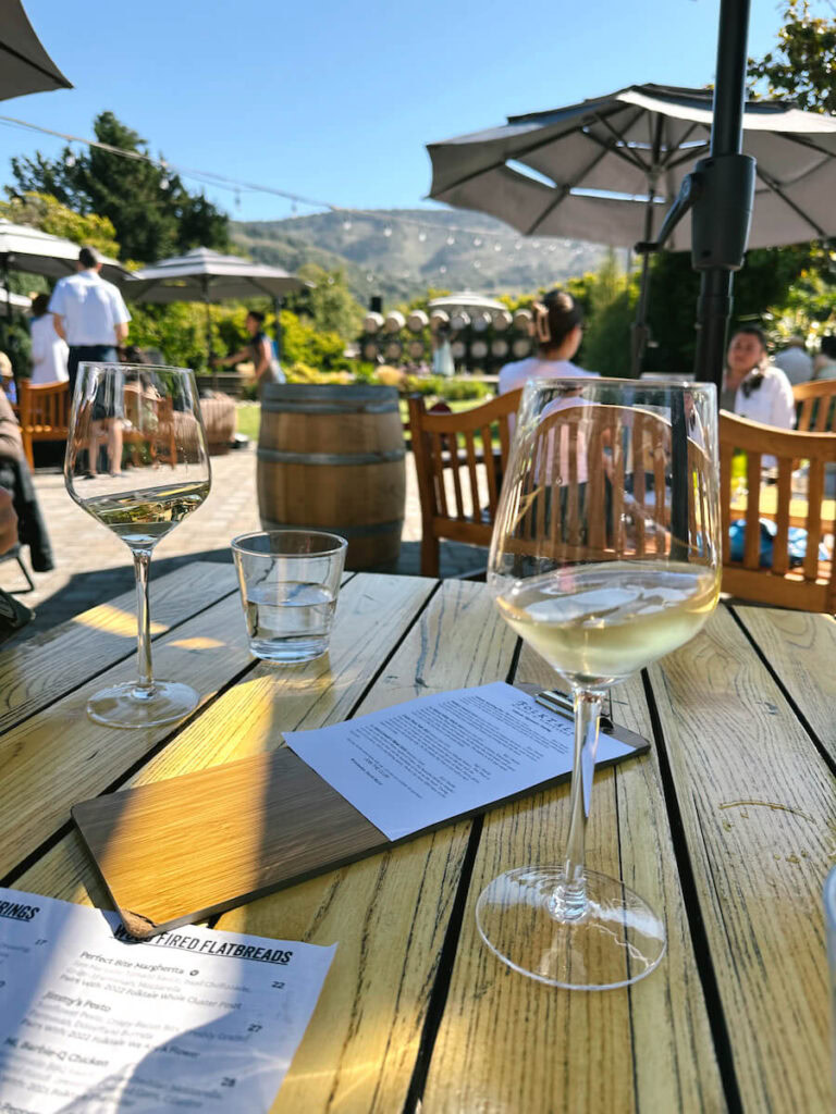 Two glasses of wine on an outdoor patio table at Folktale Winery