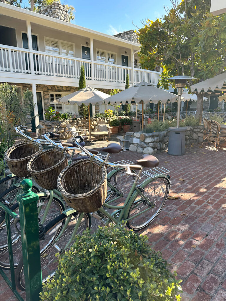 Pistachio-colored bikes with baskets on a bike rack