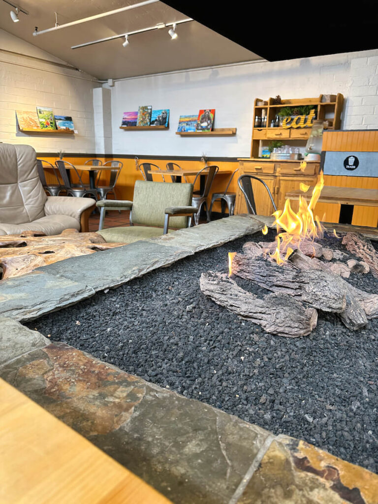 An indoor firepit with seating surrounding it at Carmel Belle restaurant