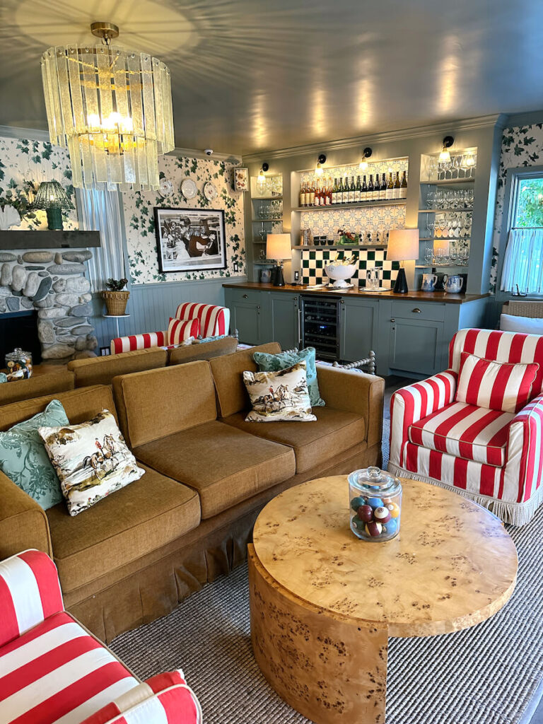 Couches and Red striped chairs in front of coffee tables in the lobby at Le Petit Pali at 8th Avenue