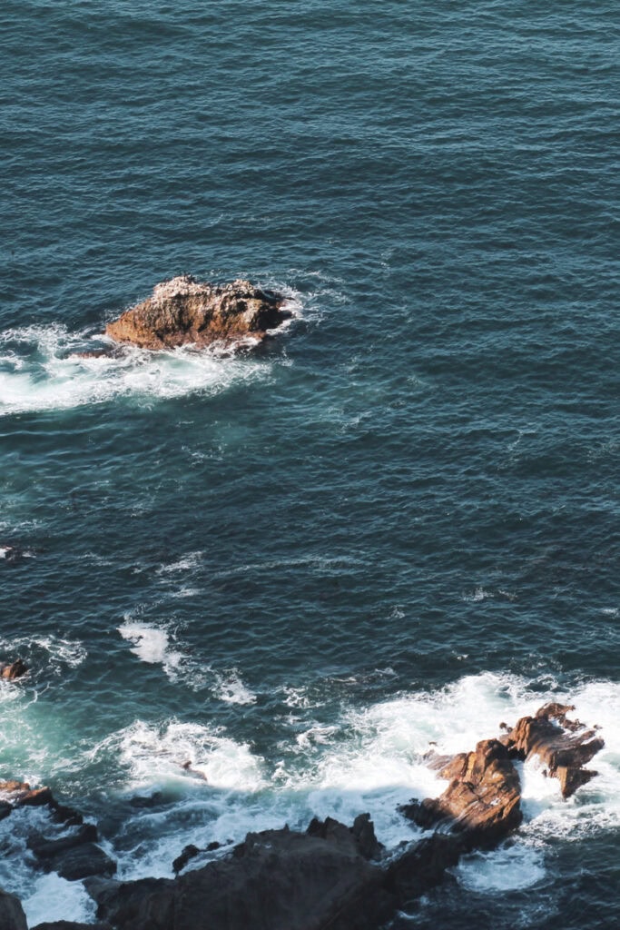 Small waves crashing against rocks in the water