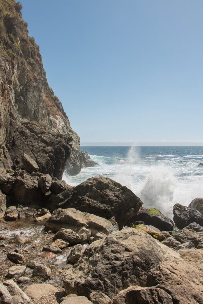 Waves crashing onto some rocks at the beach at Partington Cove