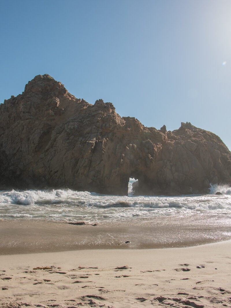 A massive boulder called Keyhole Rock in the water at Pfeiffer Beach