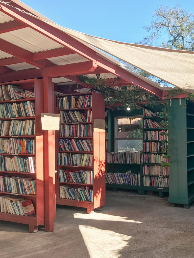 A row of red and green bookshelves at Bart's Books, an outdoor bookstore