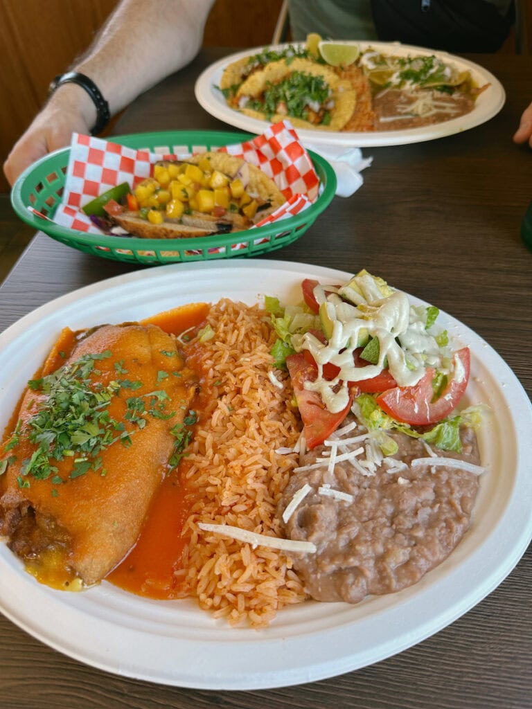 A plate of rice, beans, and an enchilada at El Cantaro