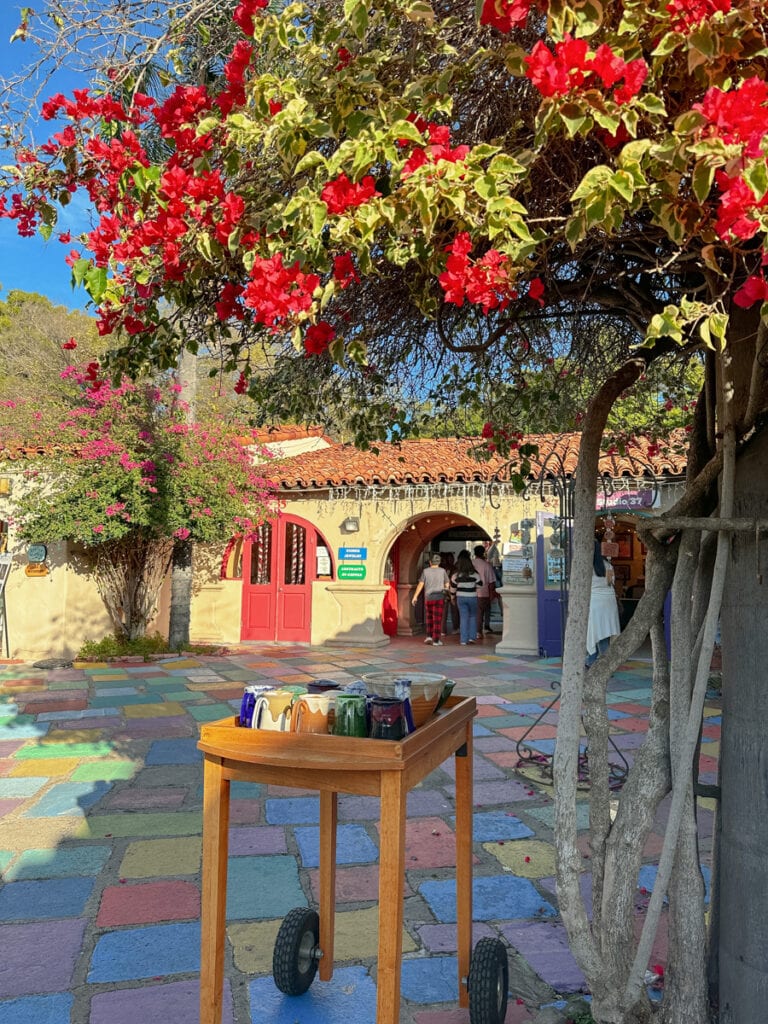 A small table with handmade mugs in front of a art shop in Old Town