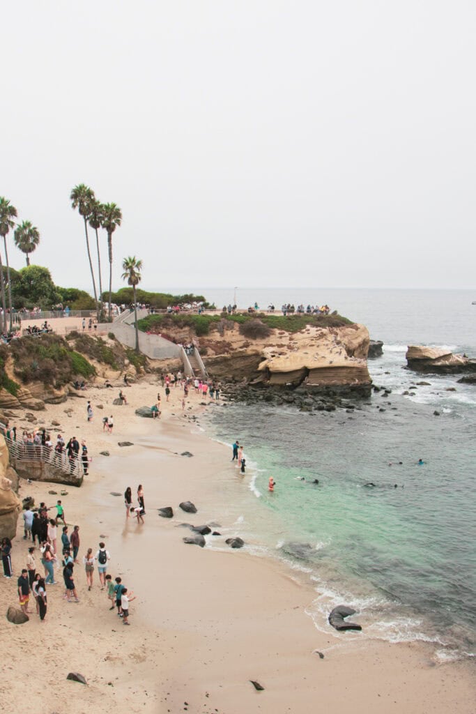 People on the beach at La Jolla Cove on a foggy day