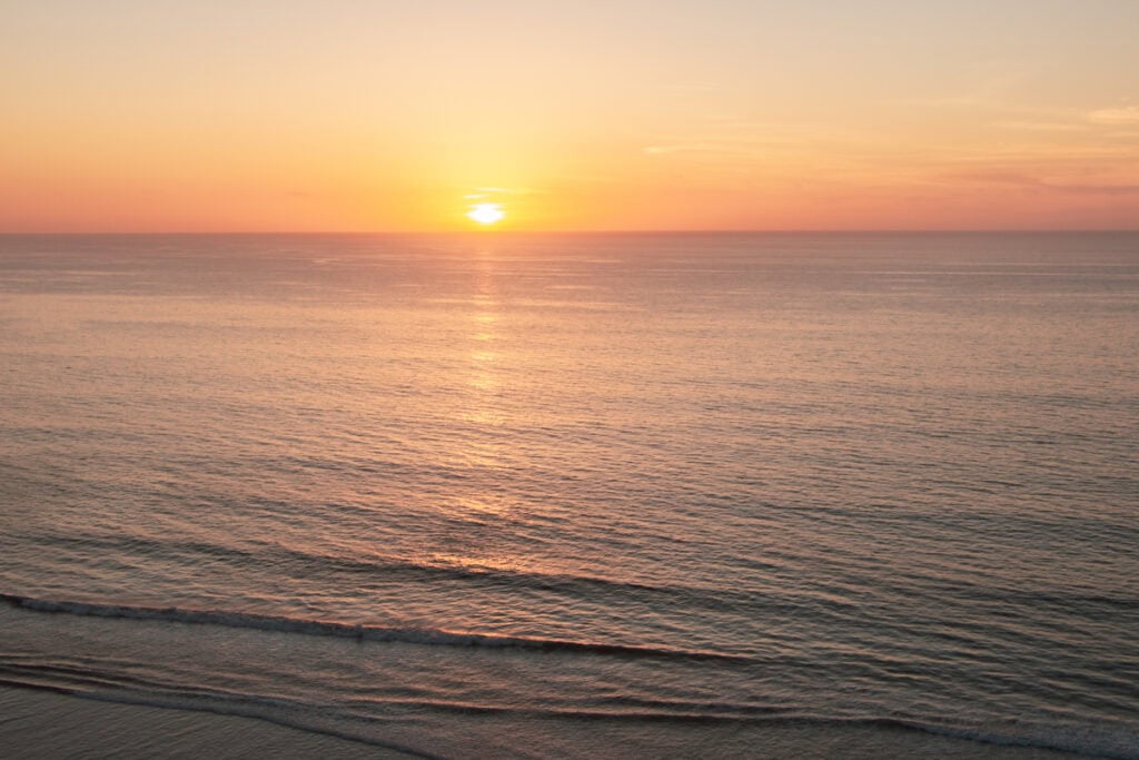 The sun setting over the ocean