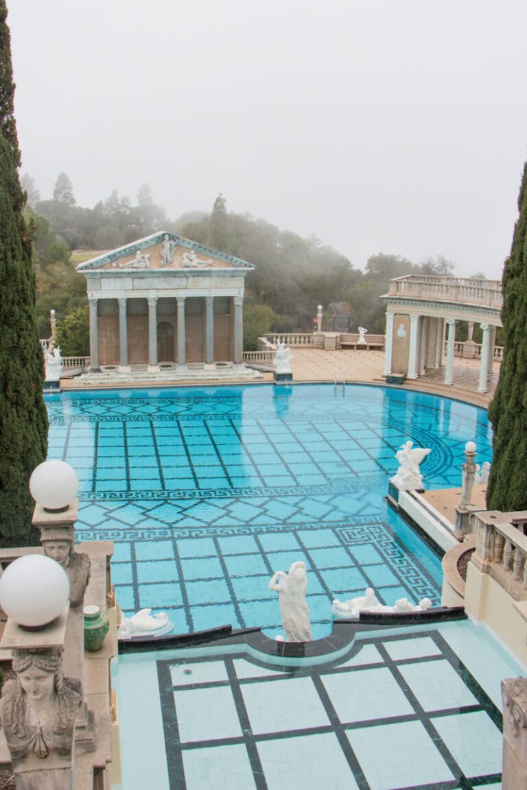 An oversized pool surrounded by Greek-inspired columns and architecture at Hearst Castle