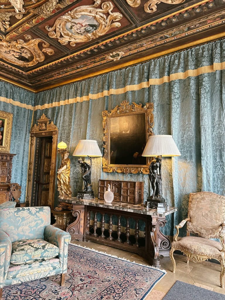 A sitting room in Hearst Castle with blue drapery on the walls