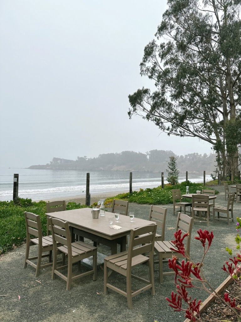 A couple tables in front of the ocean at Hearst Ranch Winery