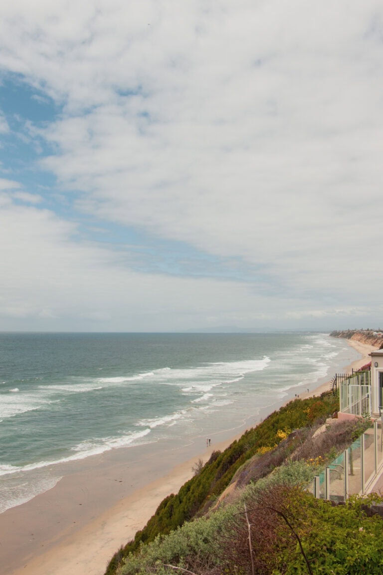 View of Moonlight Beach from the I Street Viewpoint in Encinitas. The beach is below, and there is a home on the coastal cliff on the right.