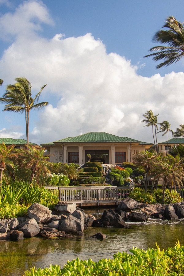 The main lobby building at the Grand Hyatt Kauai, with man-made waterfalls and lush landscaping in front of it