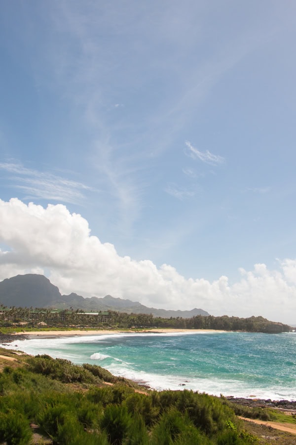The view of Shipwreck Beach in the distance, with towering mountains behind it