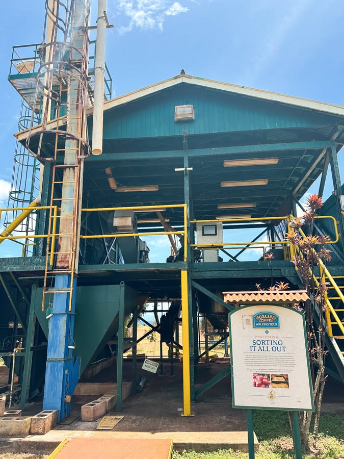 Large teal and yellow coffee machinery at Kauai Coffee Company