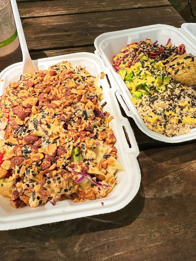 Two bowls of food in to-go containers