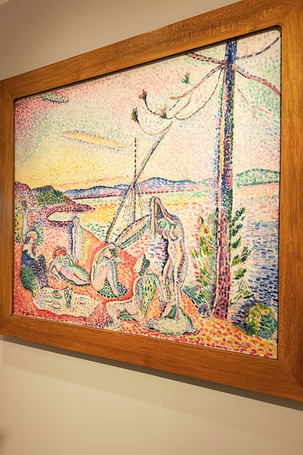 A multicolored painting inside of a wooden frame at the Matisse Museum