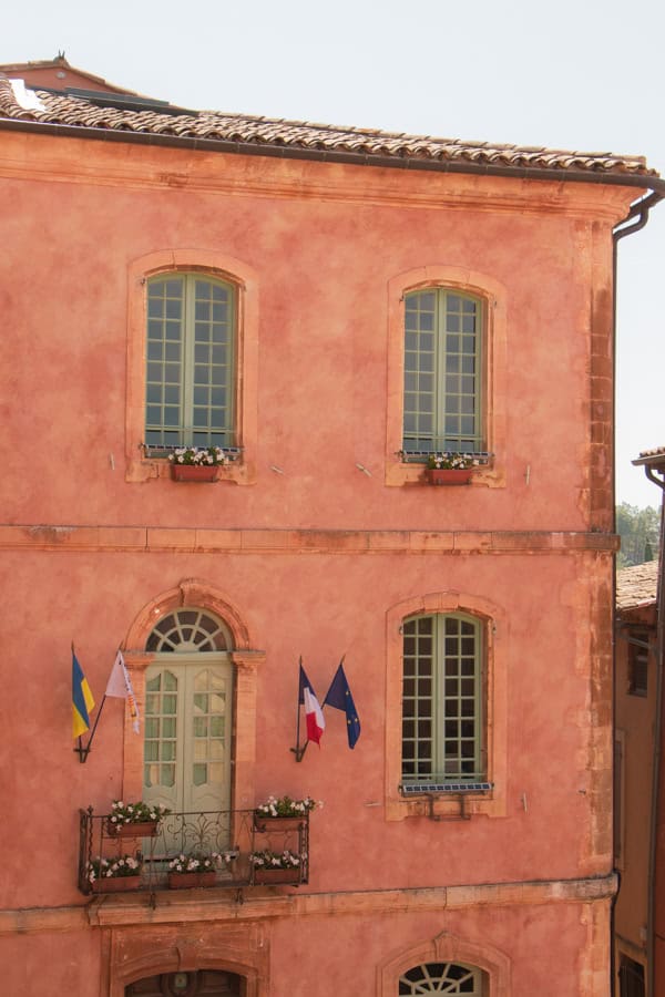 A salmon-colored building with light green-blue trimming
