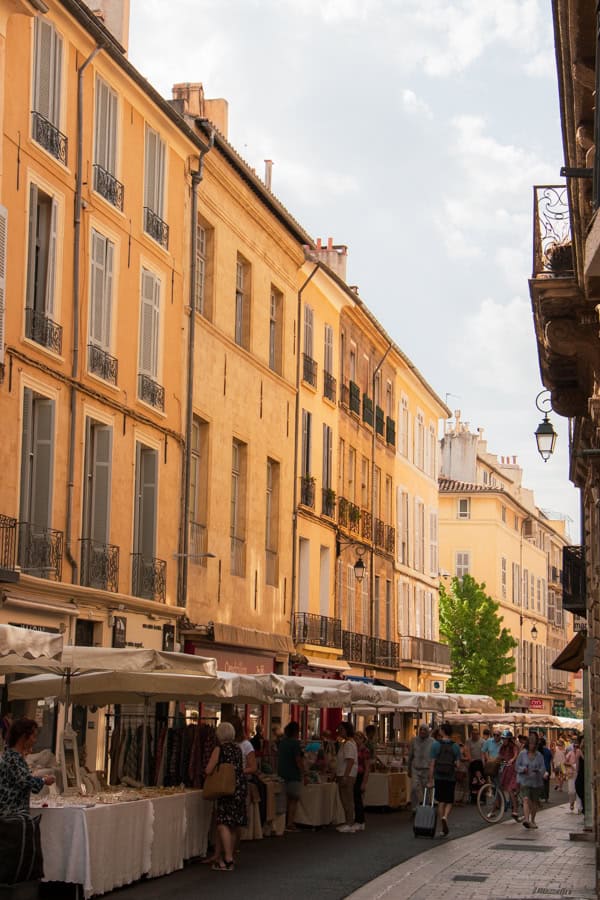 Market stalls lining a pedestrian street in Aix en Provence