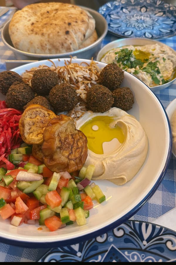 A plate of falafel, hummus, and more at Tita