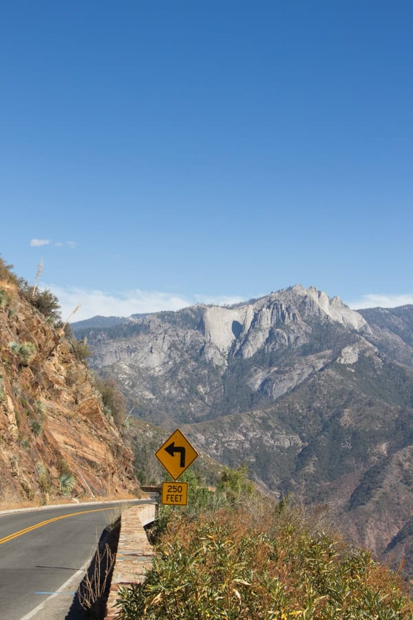 A view from a vista point on Generals Highway. You can see the mountains in the distance, and the curve of the road in the foreground.