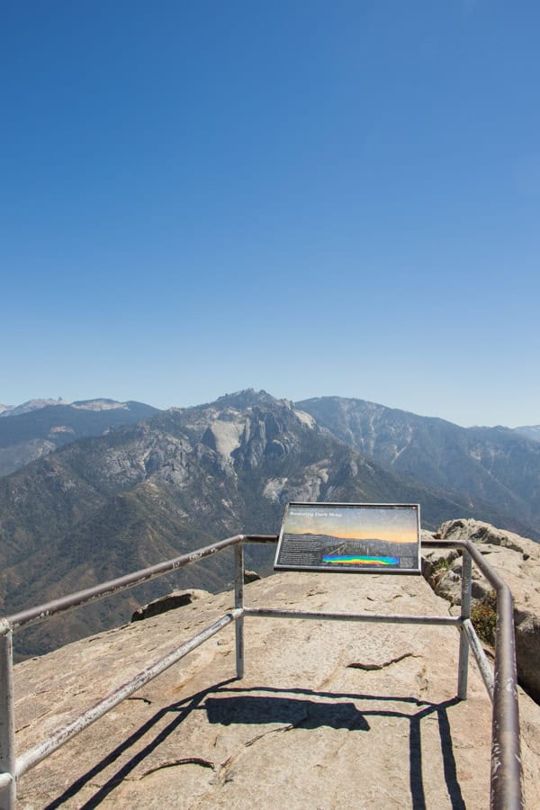 An educational placard at the end of the Moro Rock Trail, with the sweeping views of the valley in the distance.